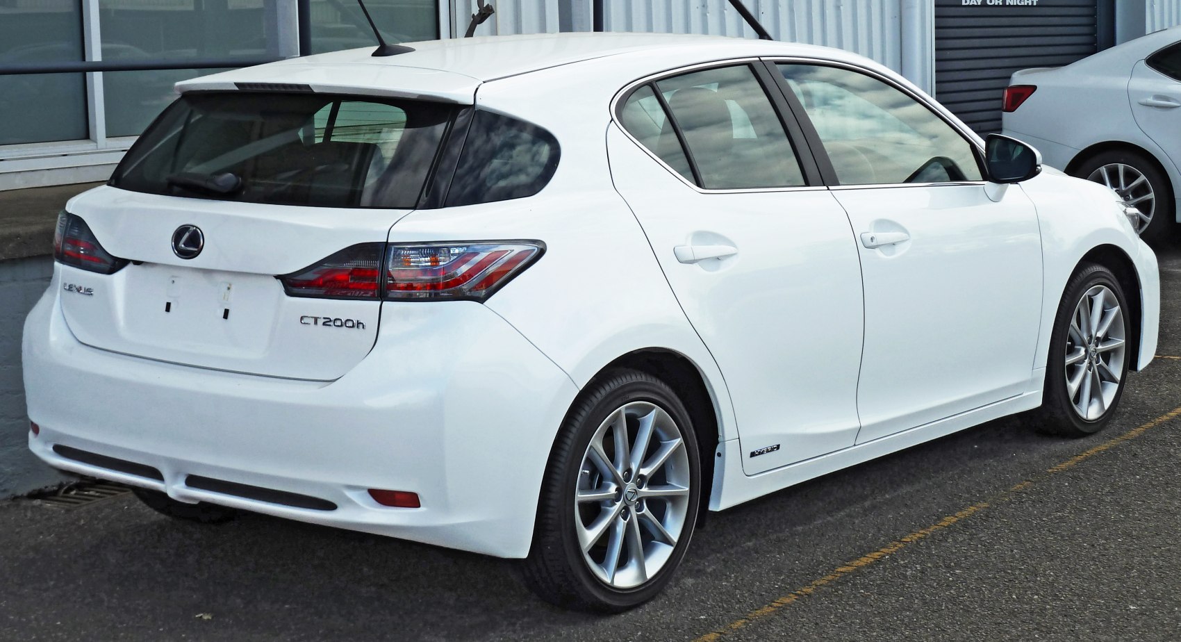 Rear and side view of a white hybrid hatchback with distinctive taillights and alloy wheels