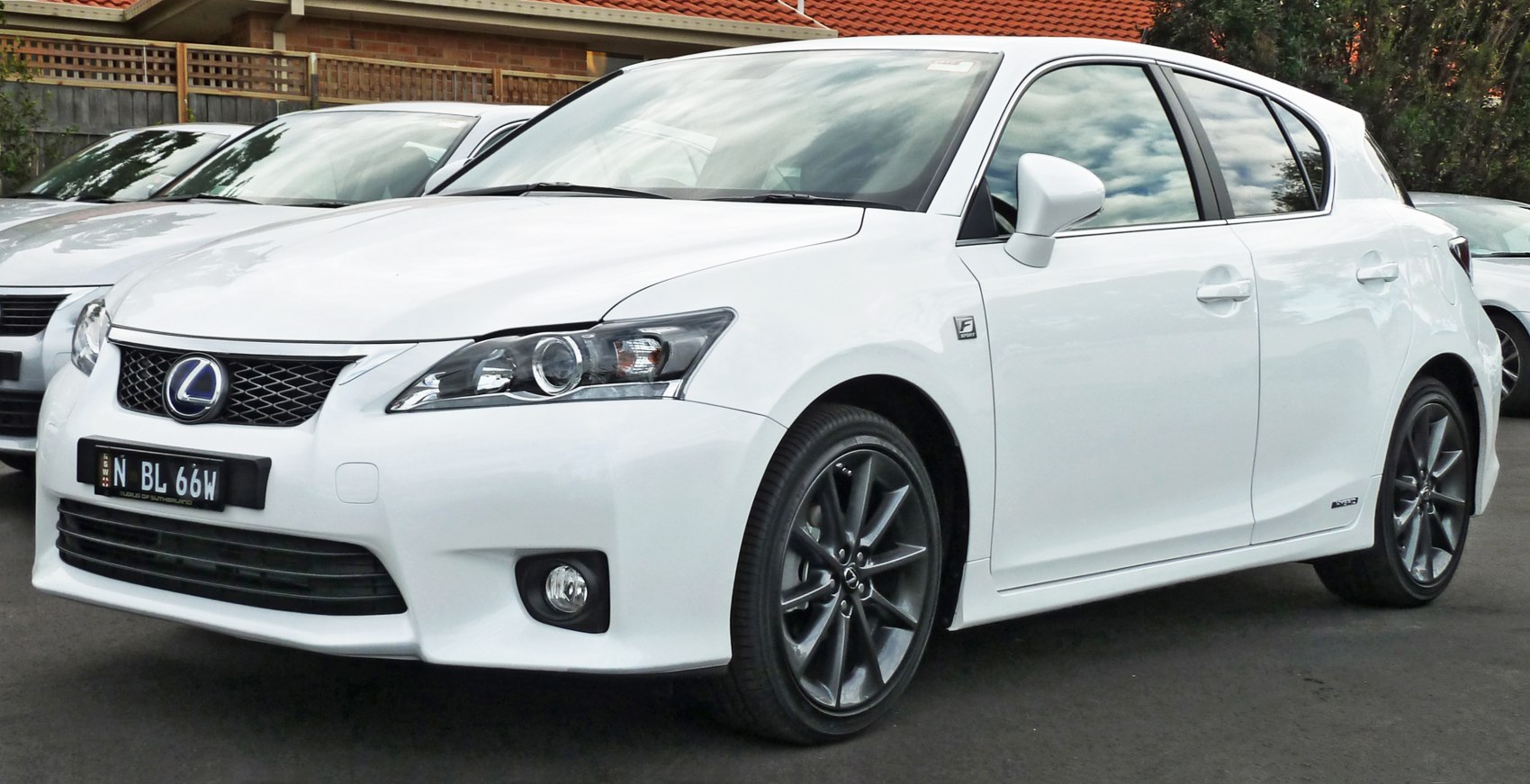 White hatchback with sporty wheels and F-Sport badge