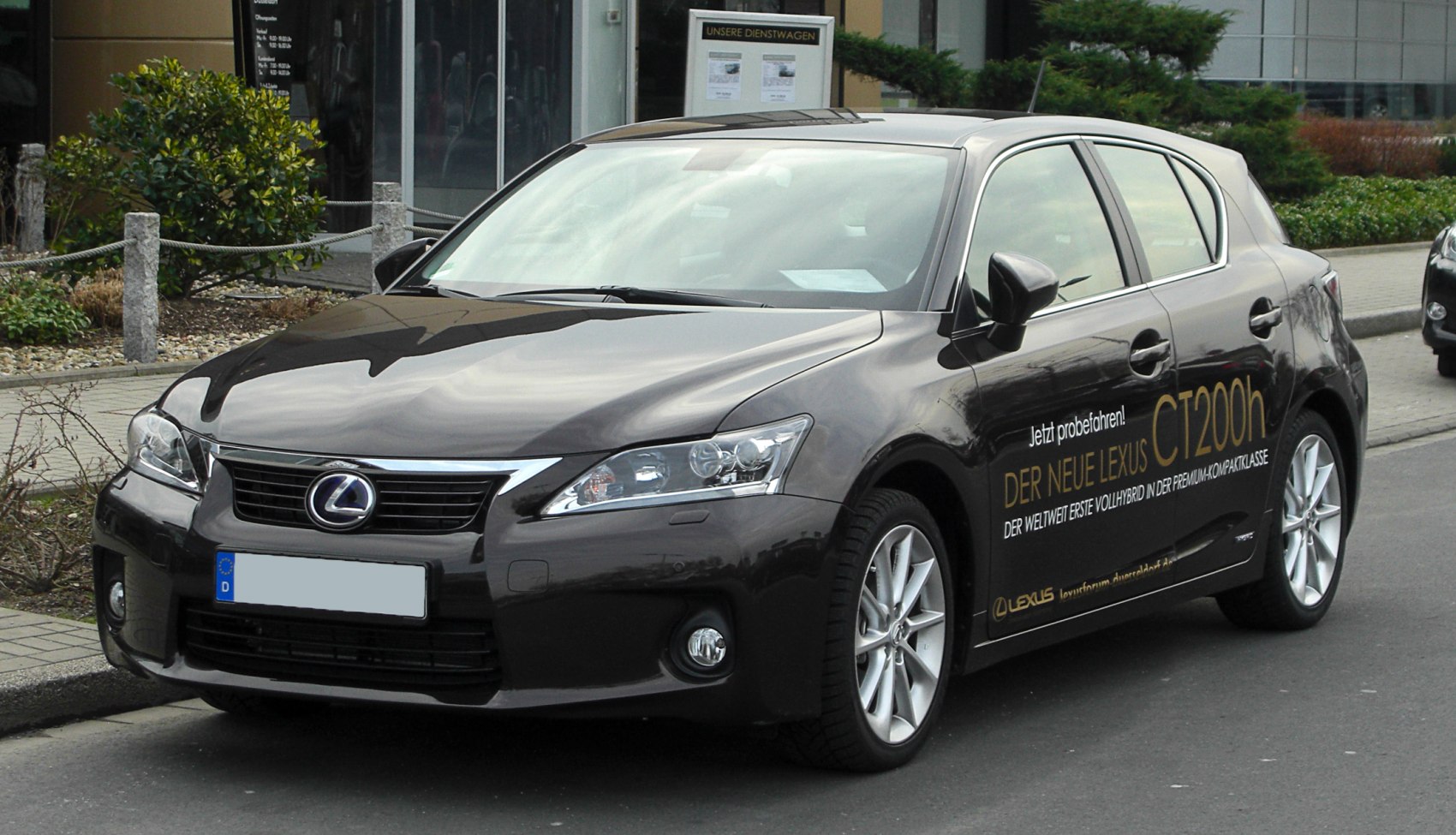 Front-side view of hybrid hatchback with sleek headlights and alloy wheels
