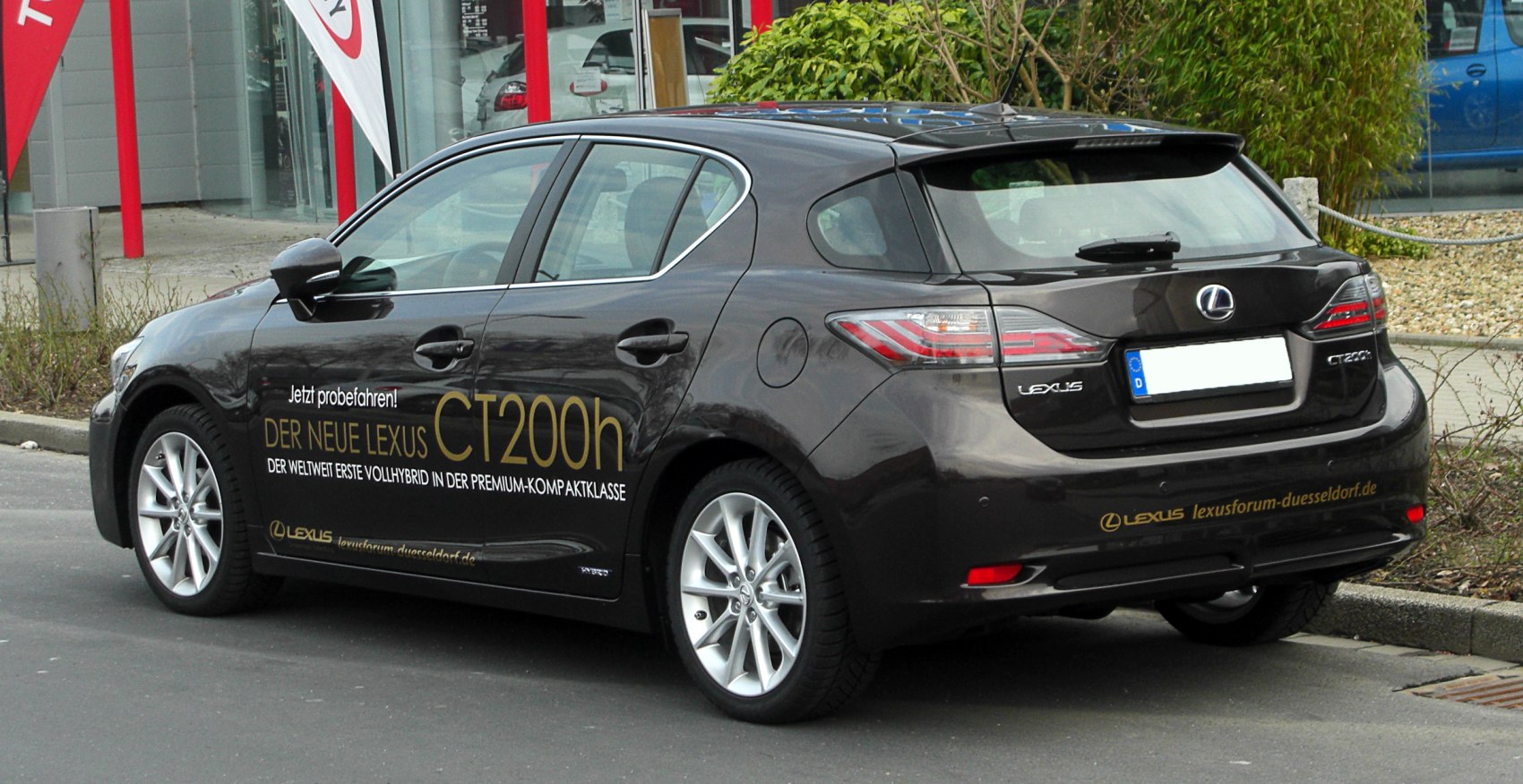 Rear side view of hybrid hatchback with distinctive taillights and sporty design.
