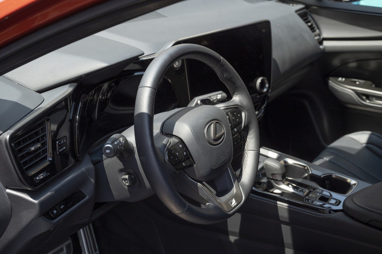 Modern steering wheel and digital dashboard in black leather interior