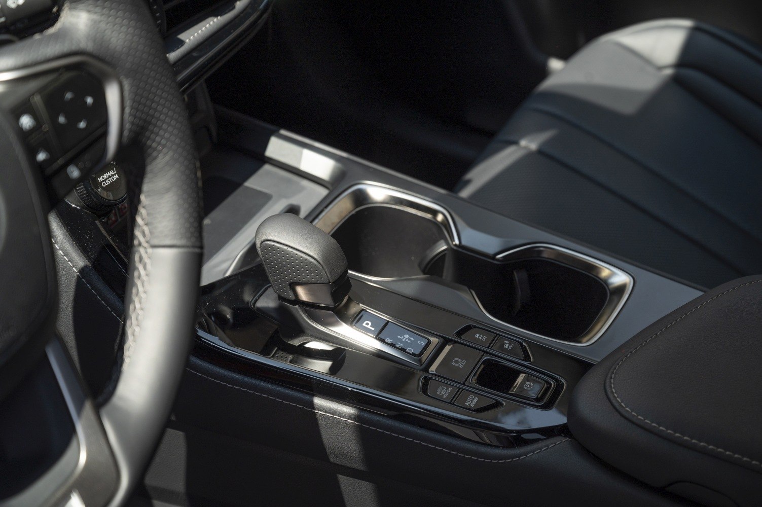 Automatic gear shifter and center console with cup holders and control buttons