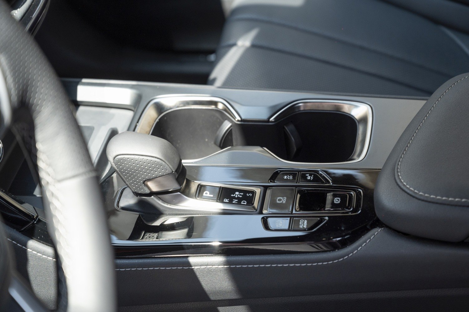 Gear shift lever and dual cup holders in center console