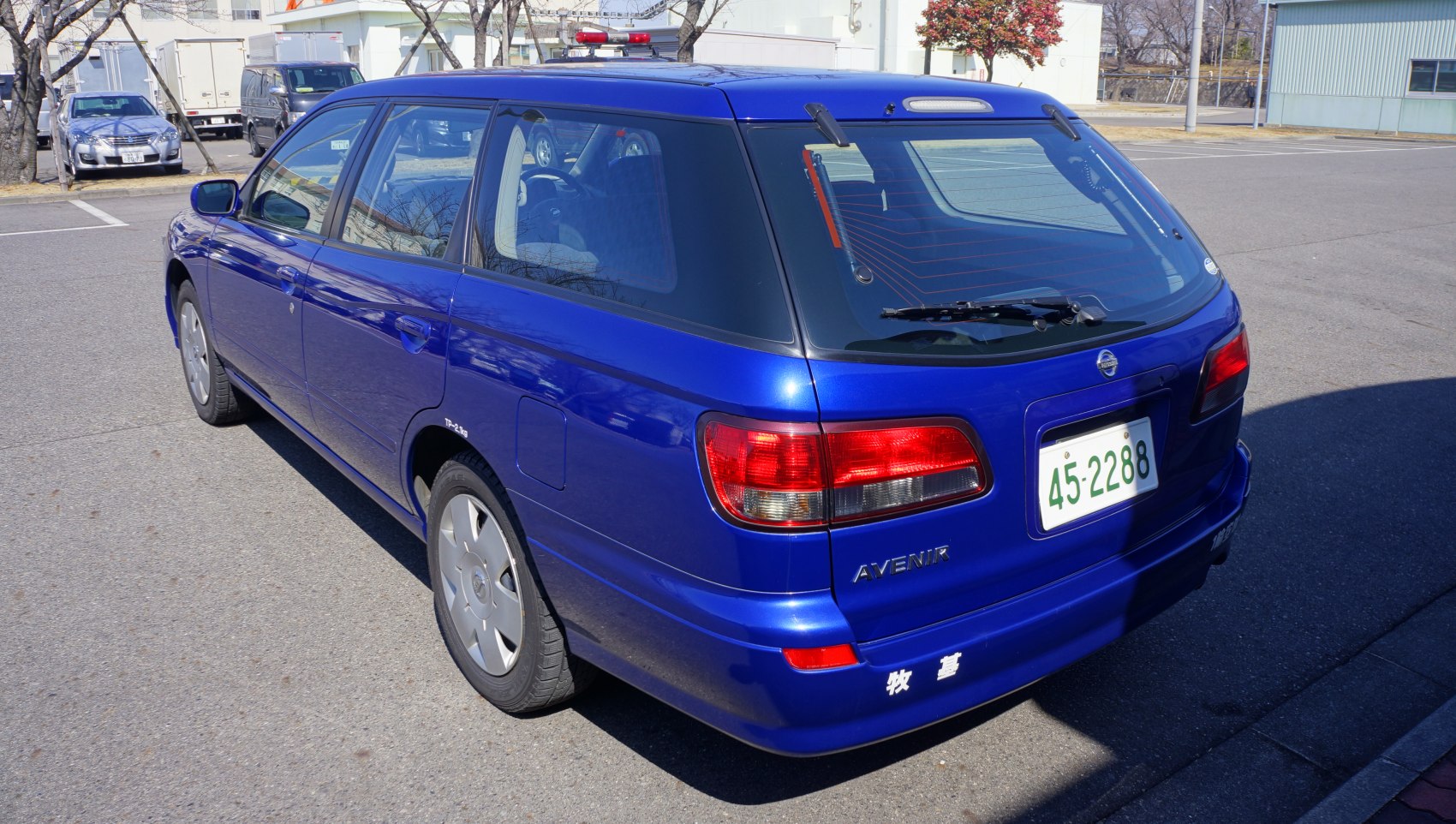 Blue wagon rear side with tail lights and rear window wiper