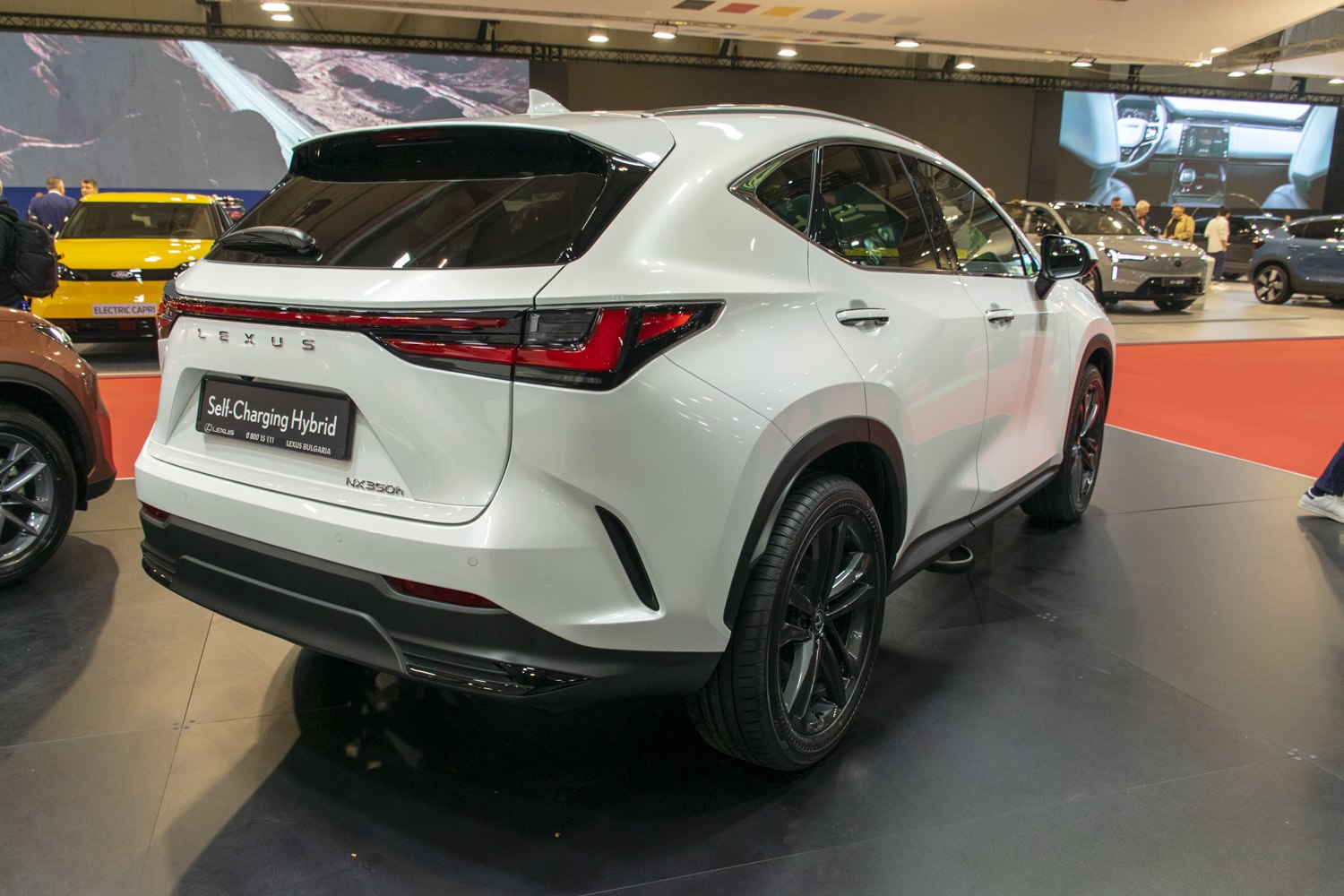 White SUV rear view with modern taillights and hybrid badge