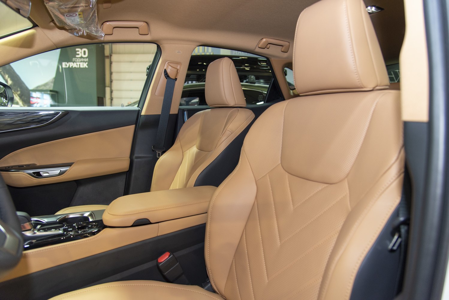 Tan leather seats with detailed stitching inside modern car interior