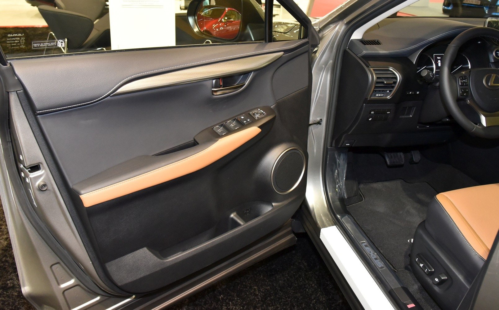 Interior door panel with controls, leather accents, and driver's seat adjustment buttons
