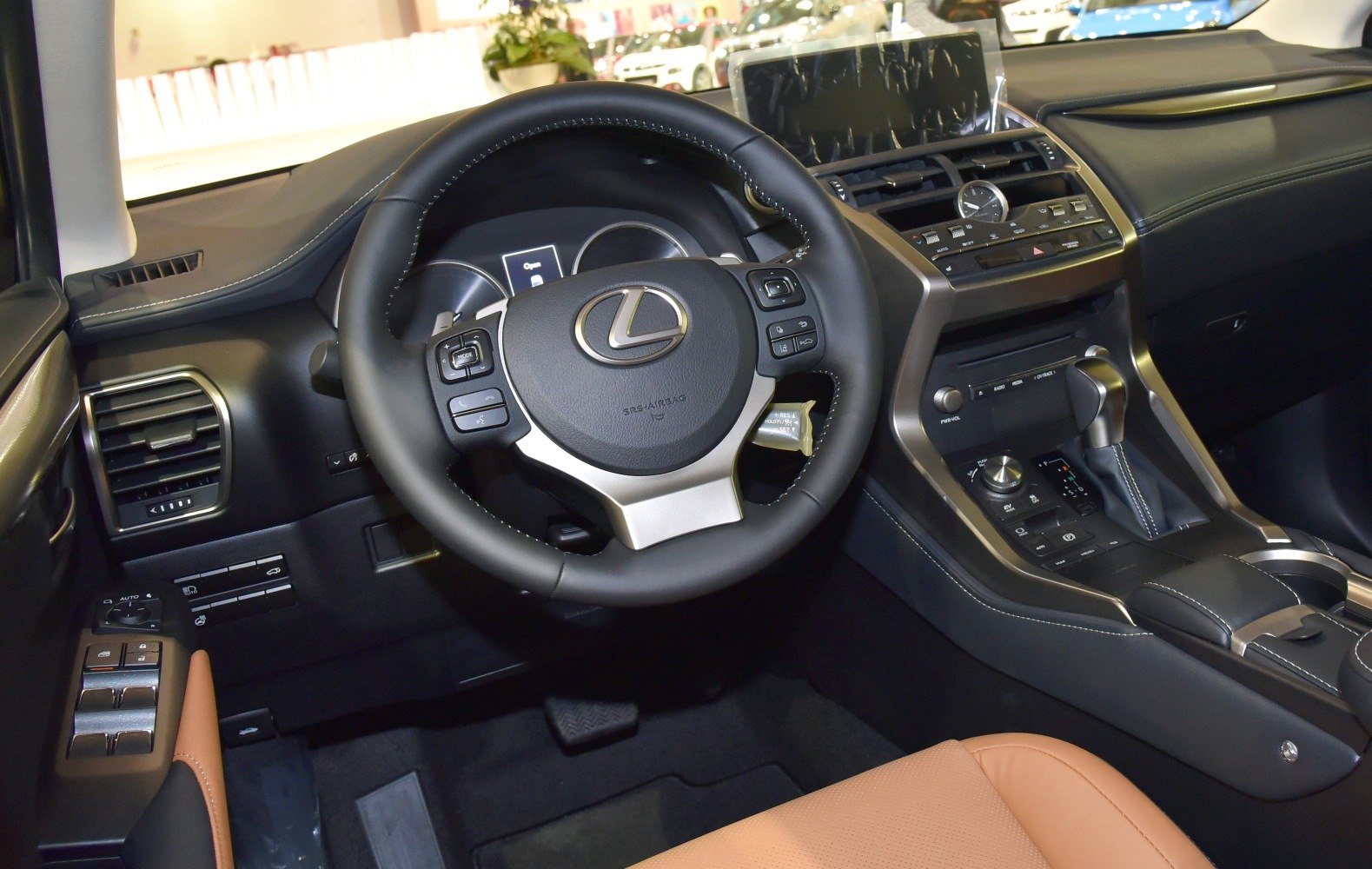 Steering wheel and dashboard with infotainment screen and control buttons