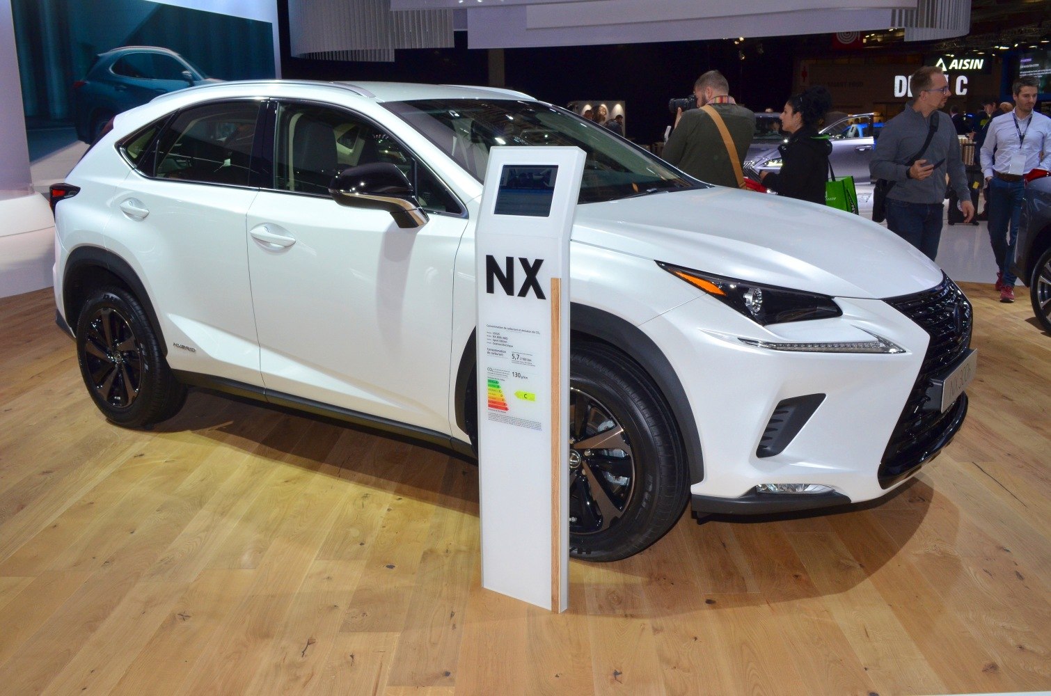 White SUV with sporty front grille and hybrid badge
