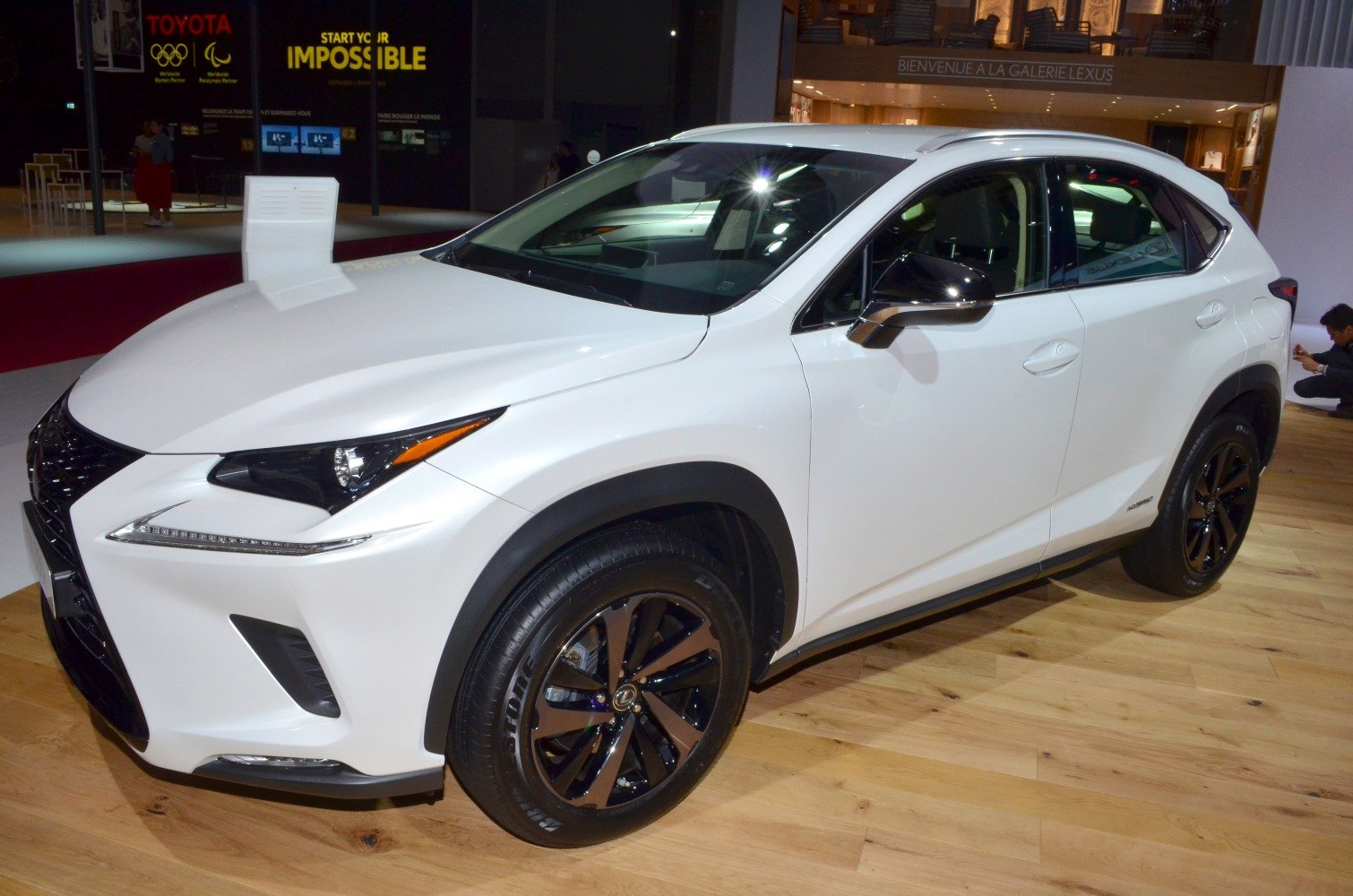 Front-side of a white SUV with black alloy wheels and sharp LED headlights