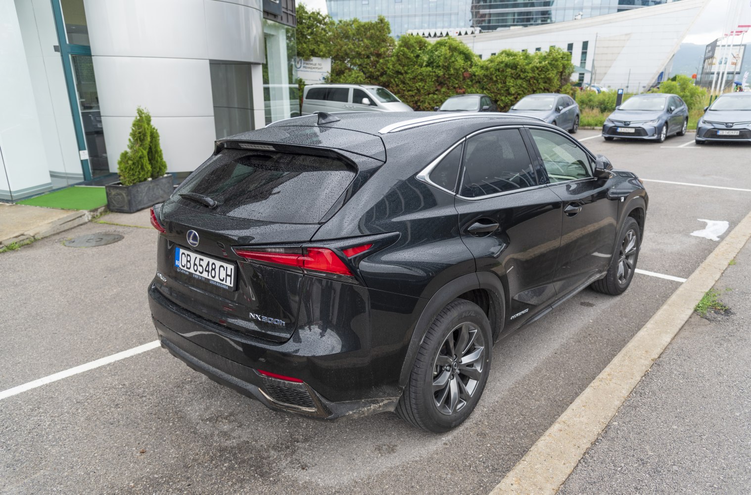Rear angle of black SUV with modern taillights and roof antenna