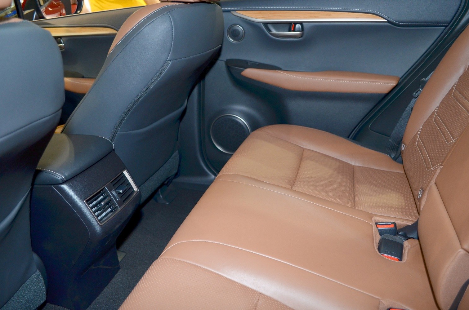 Brown leather rear seats with air vents and speaker on door panel