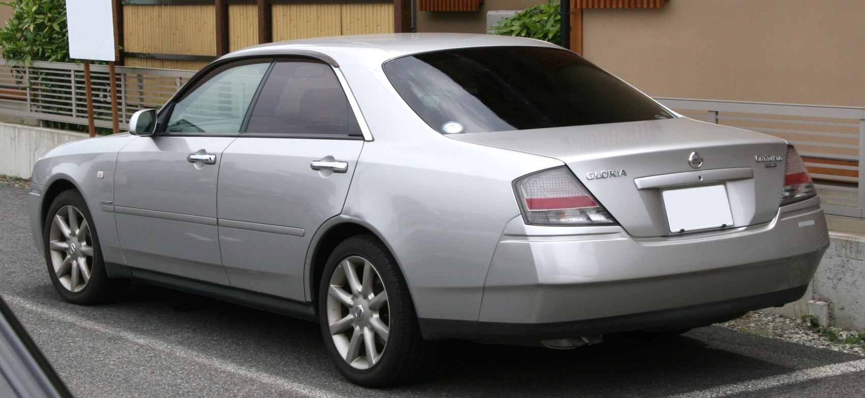 Rear-side view of silver sedan with alloy wheels and distinct taillights
