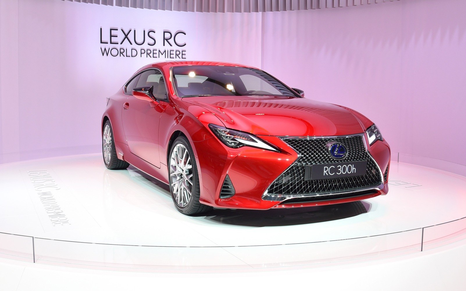 Front view of red luxury coupe with sharp LED headlights and large grille