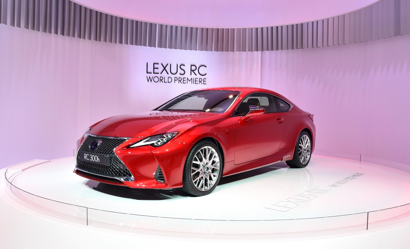 Red sports coupe with spindle grille and sharp headlights.