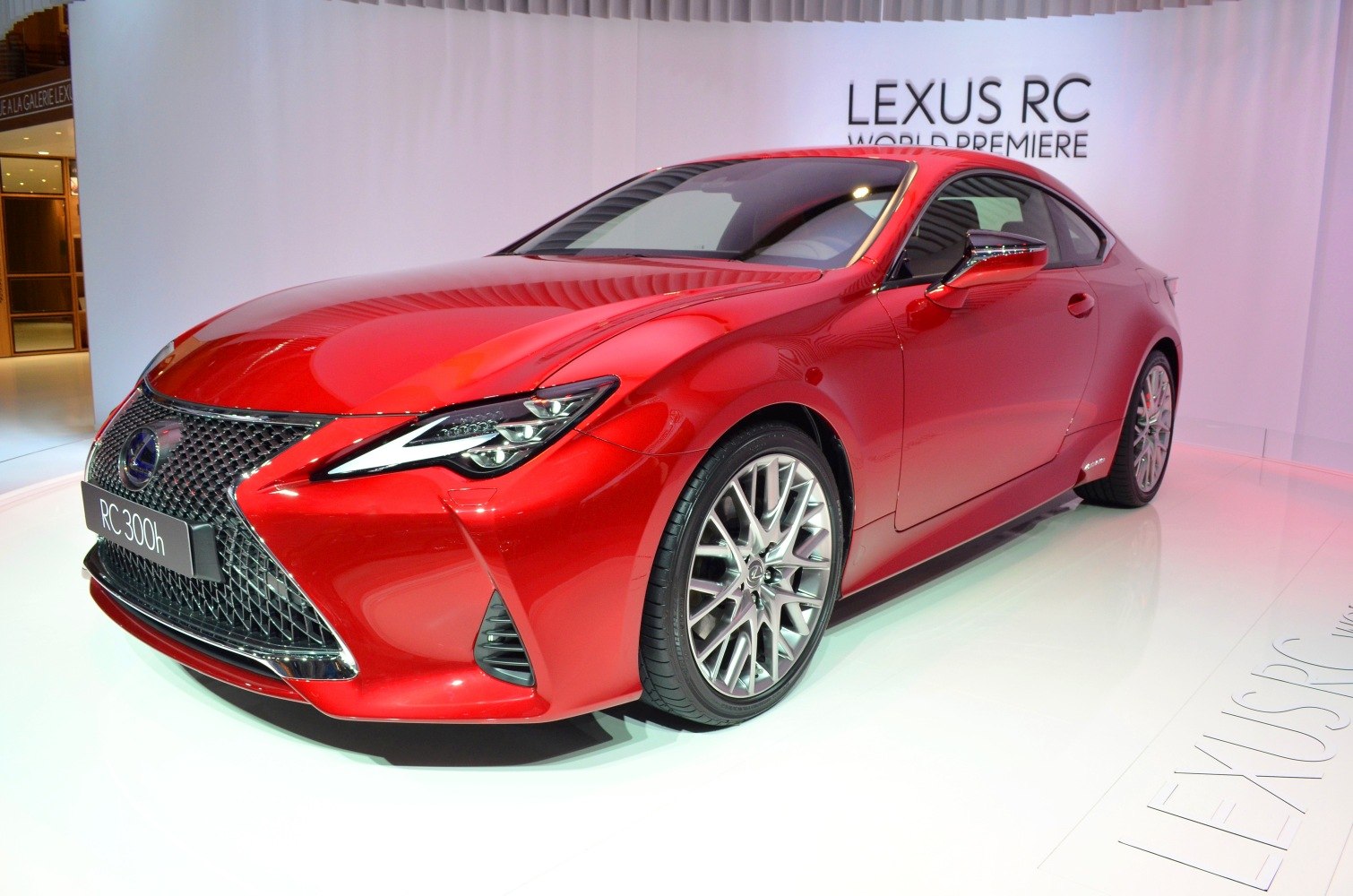 Red coupe with aggressive grille and sleek headlights front view
