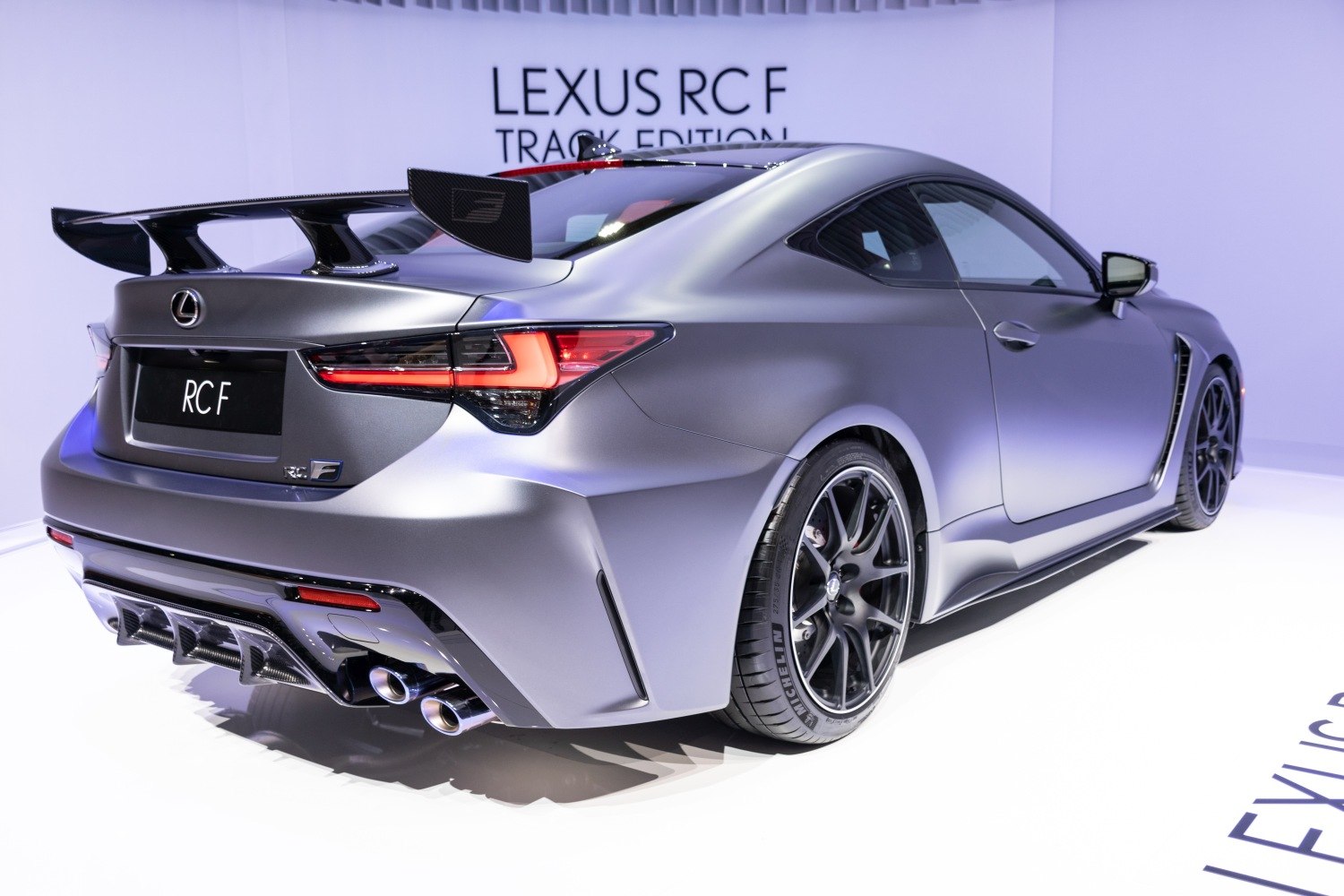 Sport coupe rear with large carbon fiber spoiler and quad exhausts