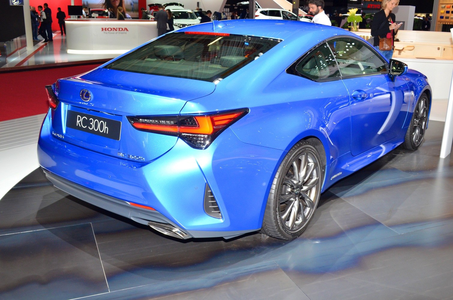 Rear view of blue coupe with LED tail lights and dual exhaust tips