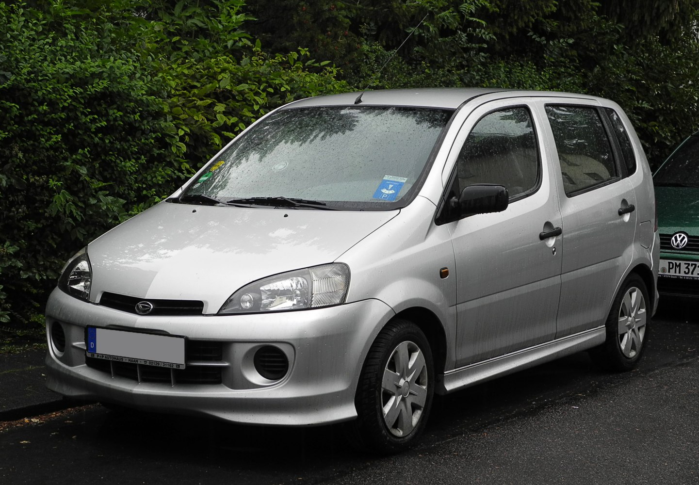Compact silver hatchback with rounded headlights and fog lights
