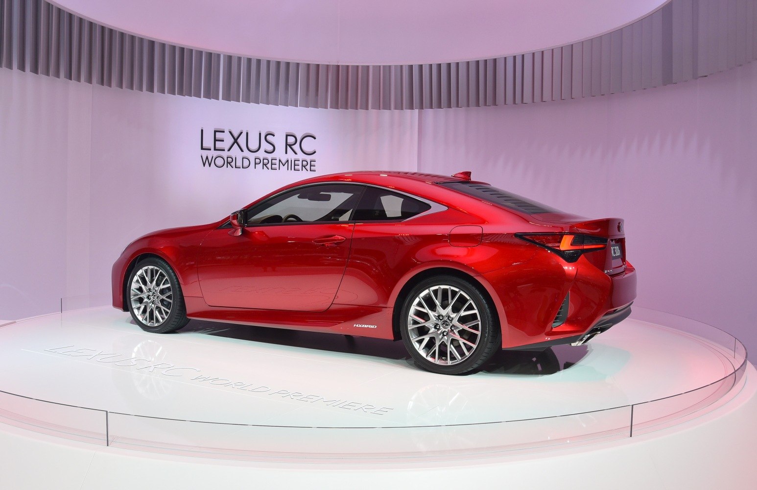 Sporty red coupe with rear spoiler and multi-spoke alloy wheels