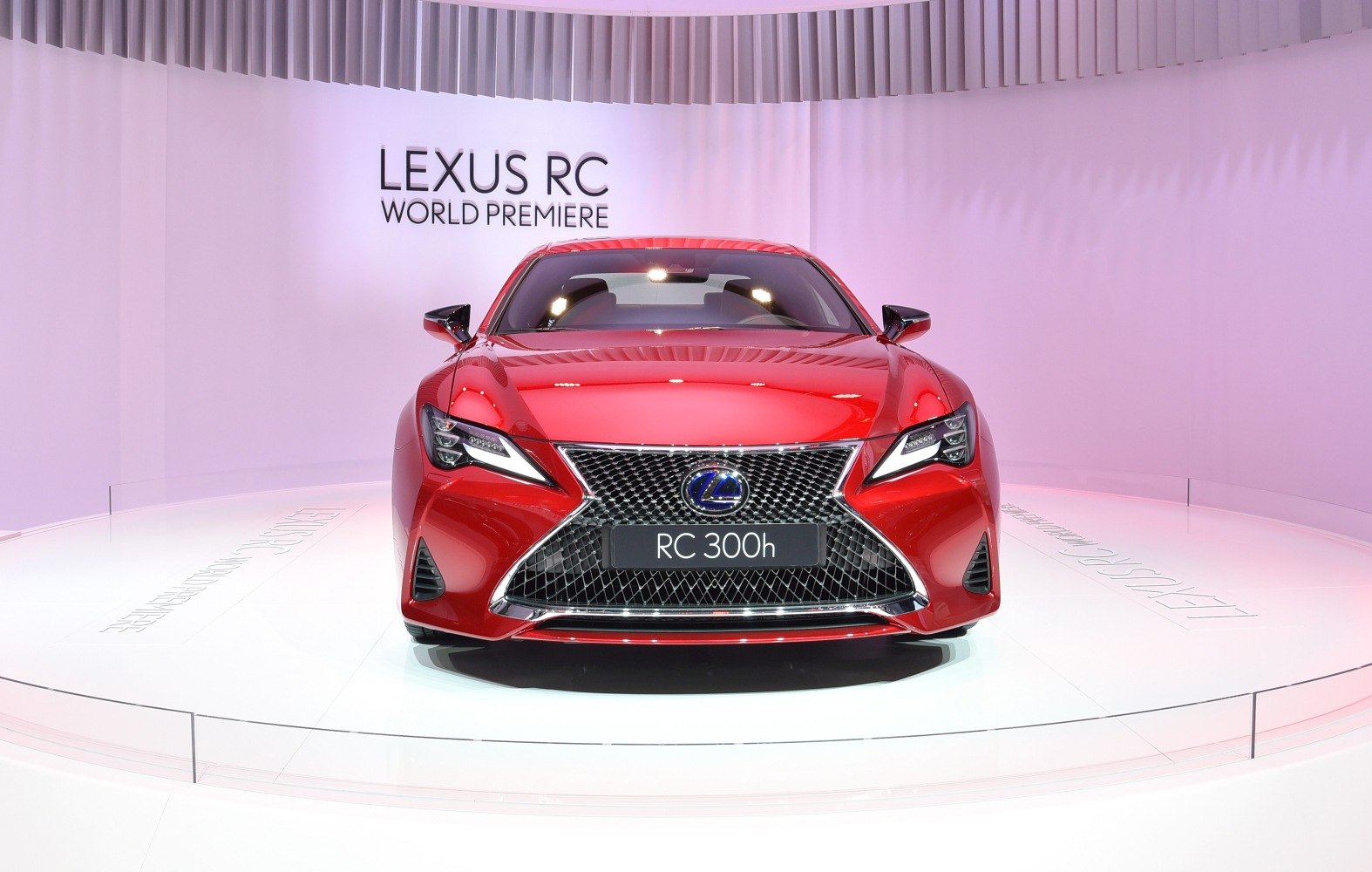 Red luxury coupe with spindle grille and aggressive LED headlights.