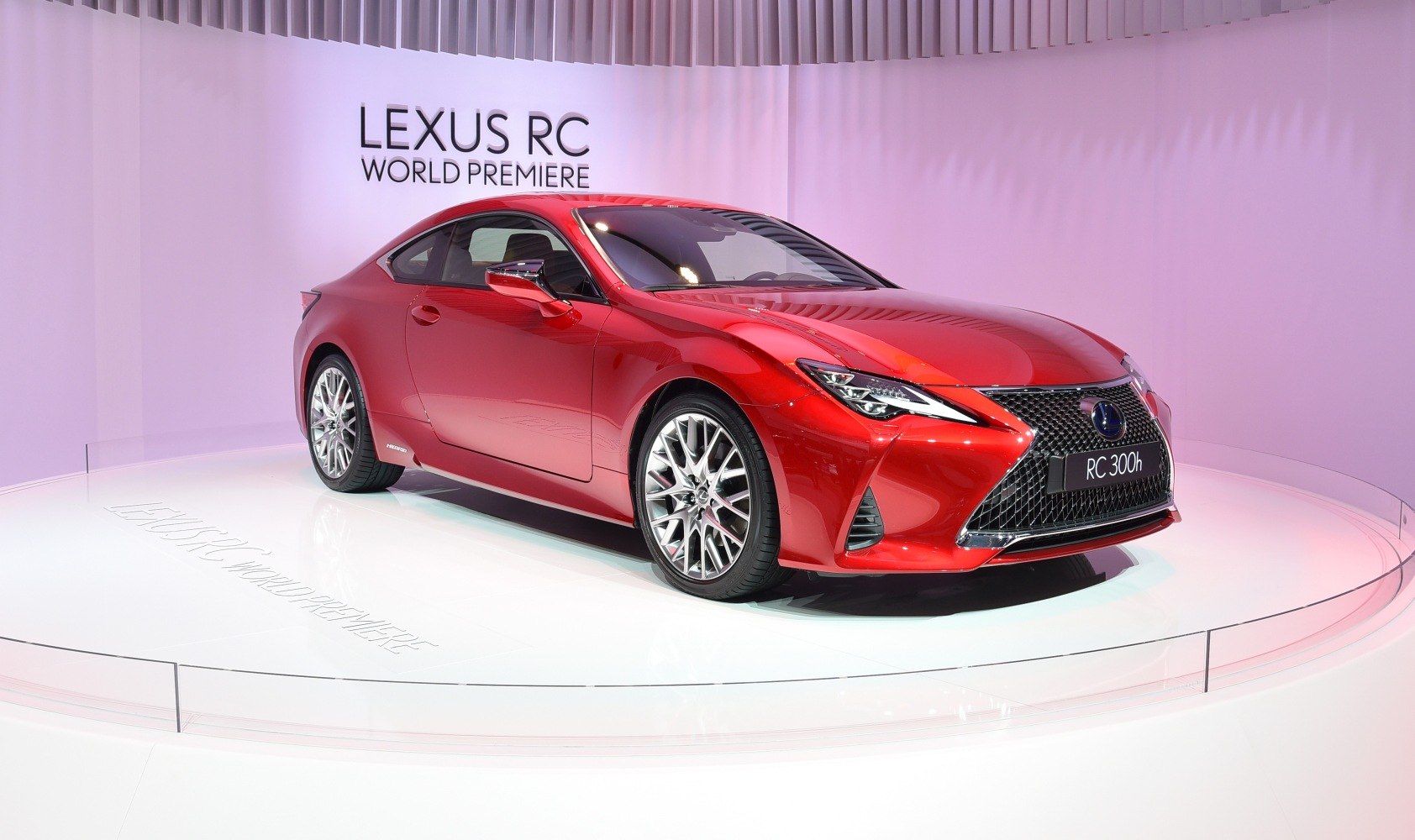 Sleek red sports coupe with aggressive front grille and LED headlights