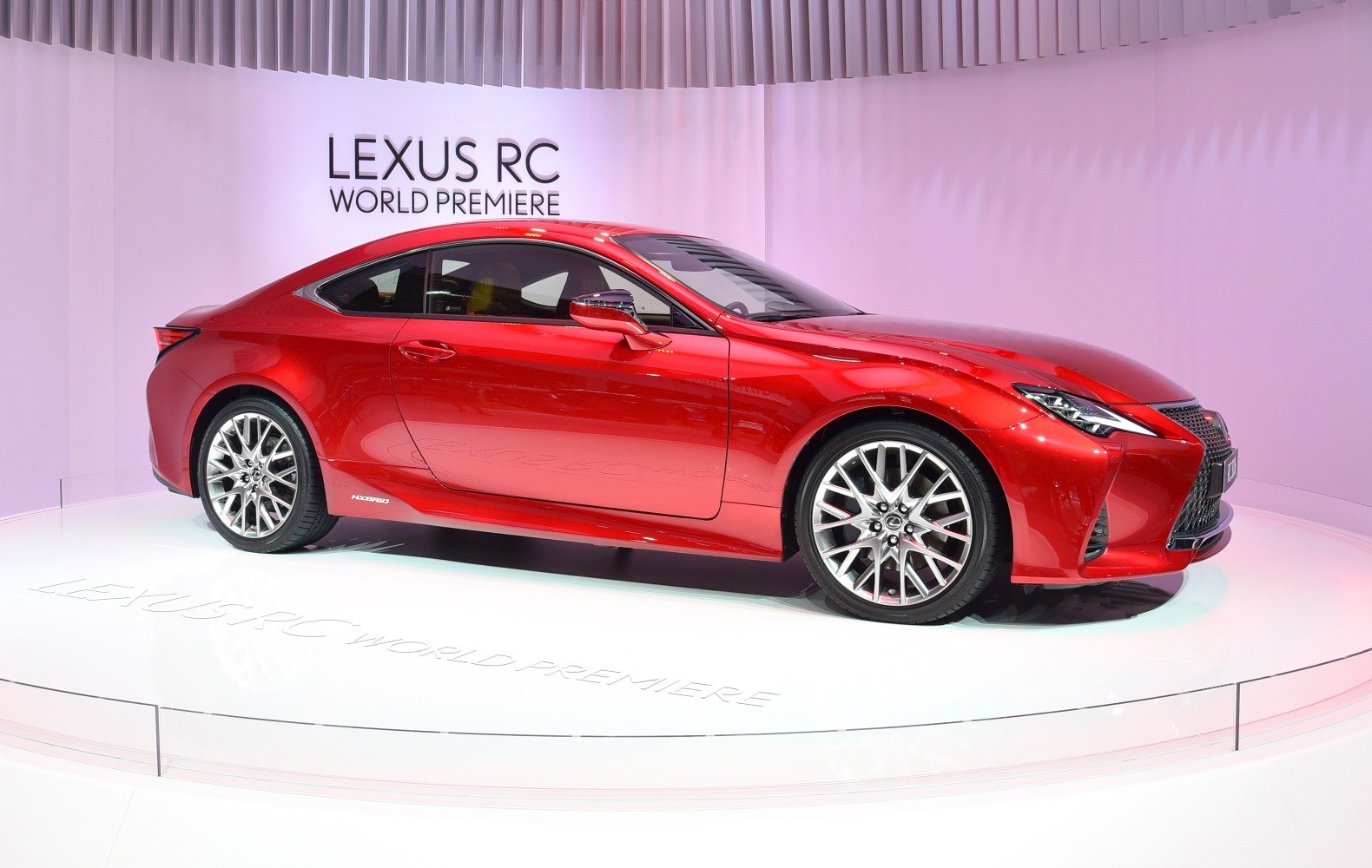 Sleek red coupe with sporty alloy wheels and sharp LED headlights
