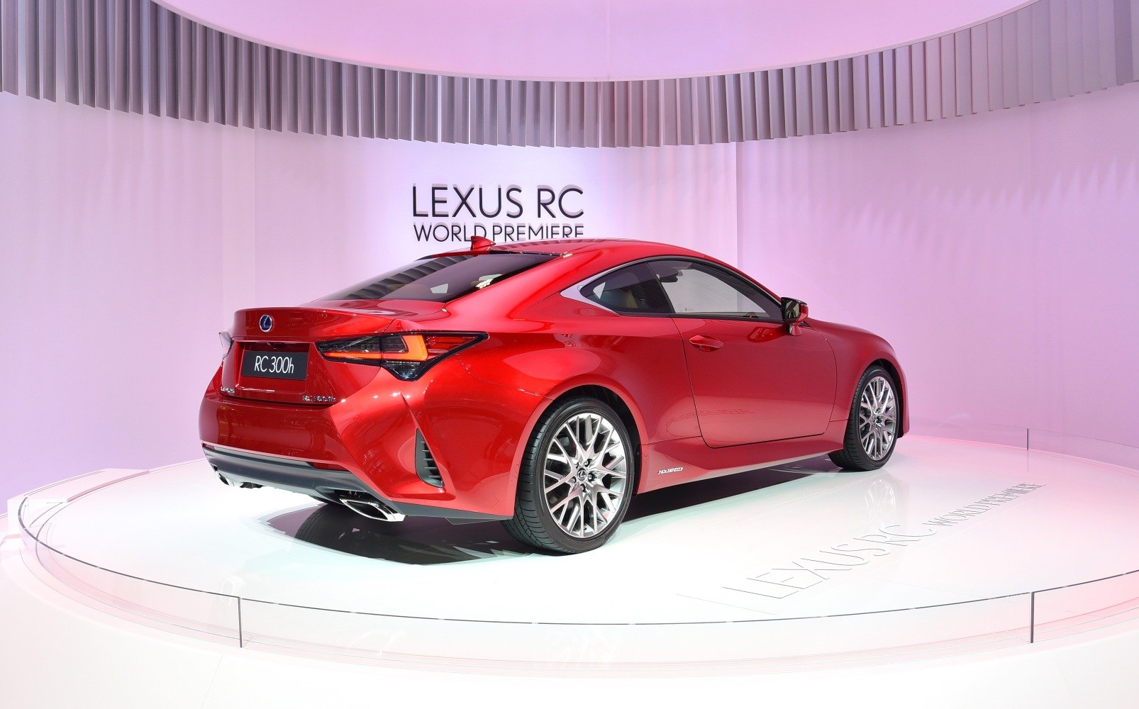 Sleek red coupe rear side view with sporty alloy wheels and dynamic design