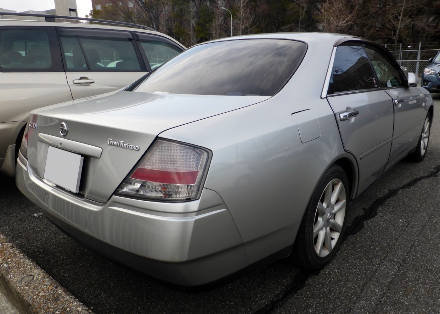 Rear view and tail light design of a silver sedan.
