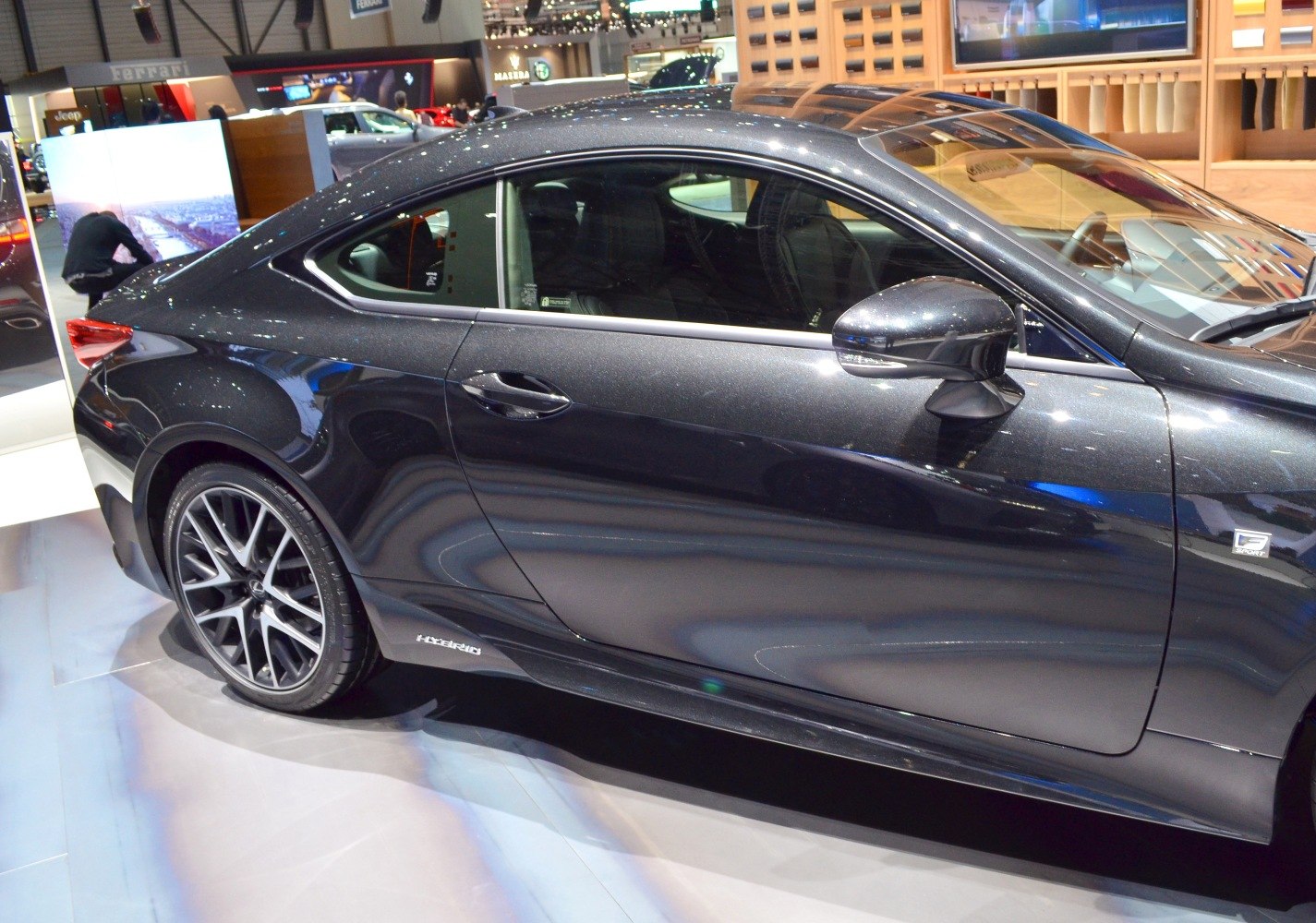 Sleek black hybrid coupe with sporty wheels, aerodynamic side profile.