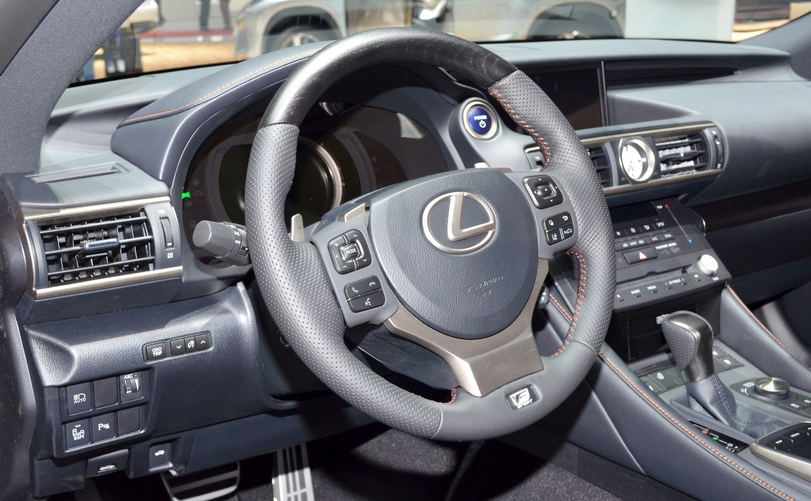 Steering wheel with controls, dashboard with infotainment, and premium interior details