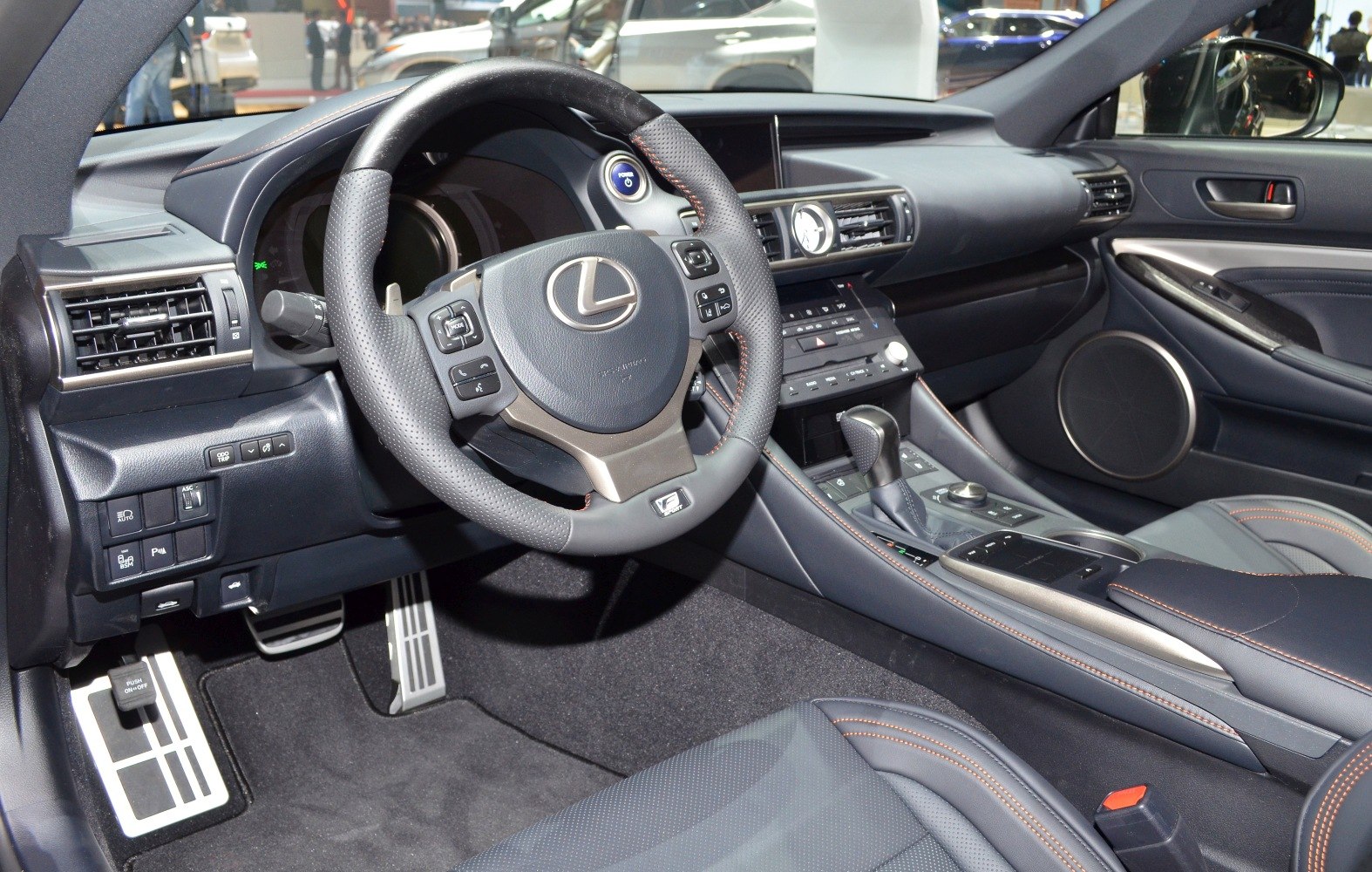 Luxury dashboard and steering wheel with center console in a sports coupe.