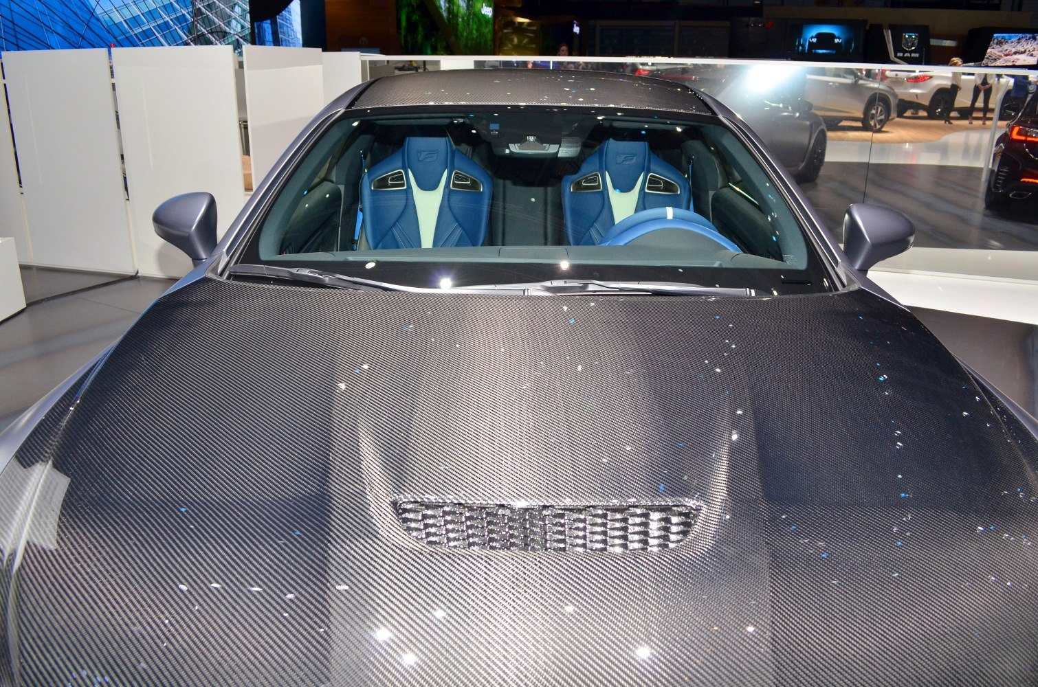 Carbon fiber hood and blue racing bucket seats
