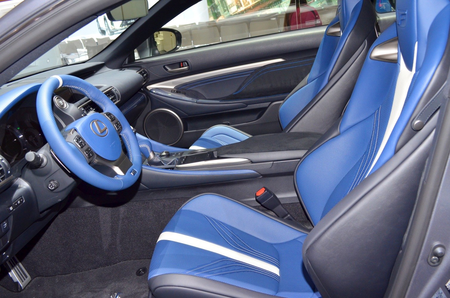 Blue sporty seats and blue steering wheel in a luxury car interior