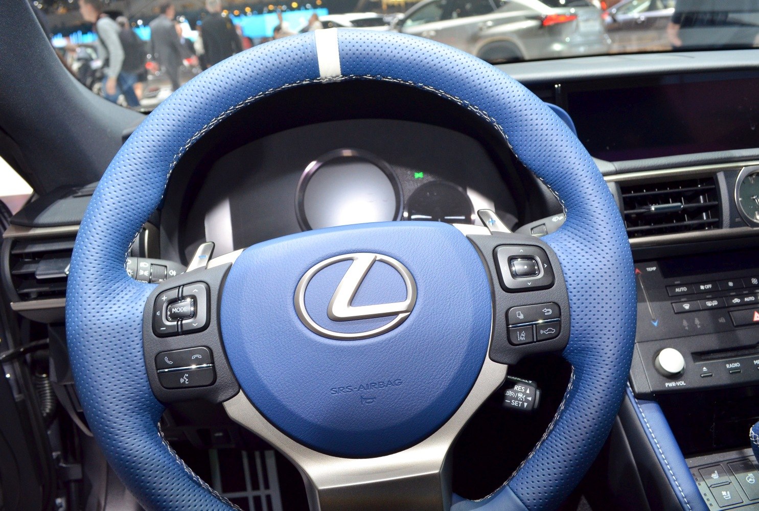 Blue perforated leather steering wheel with integrated controls and paddle shifters