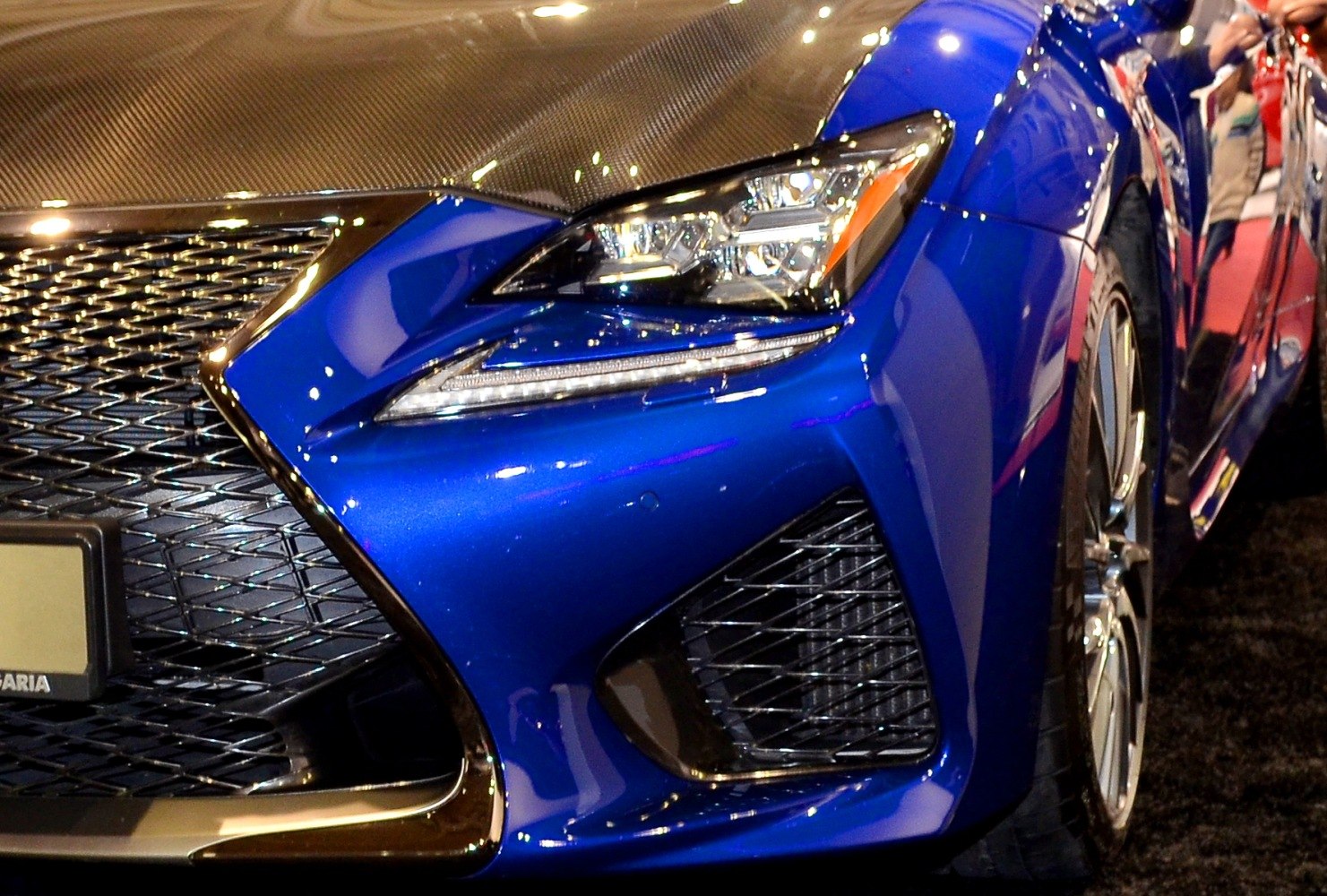 Detailed front headlight and grille with carbon fiber hood