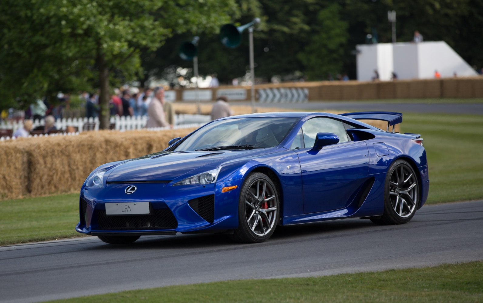 Blue sports car with rear wing and vent styling