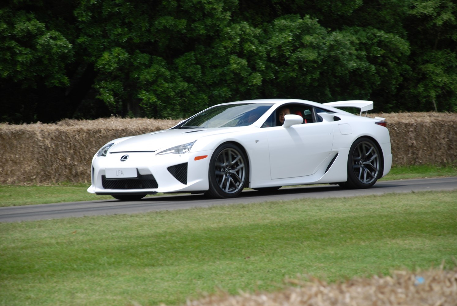 Aerodynamic white sports coupe with rear spoiler and performance wheels