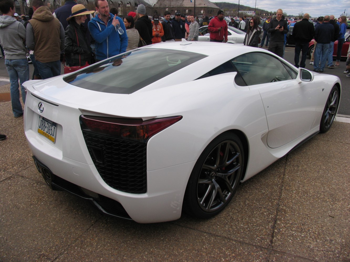 Rear and side view of sleek sports coupe with aerodynamic design and alloy wheels