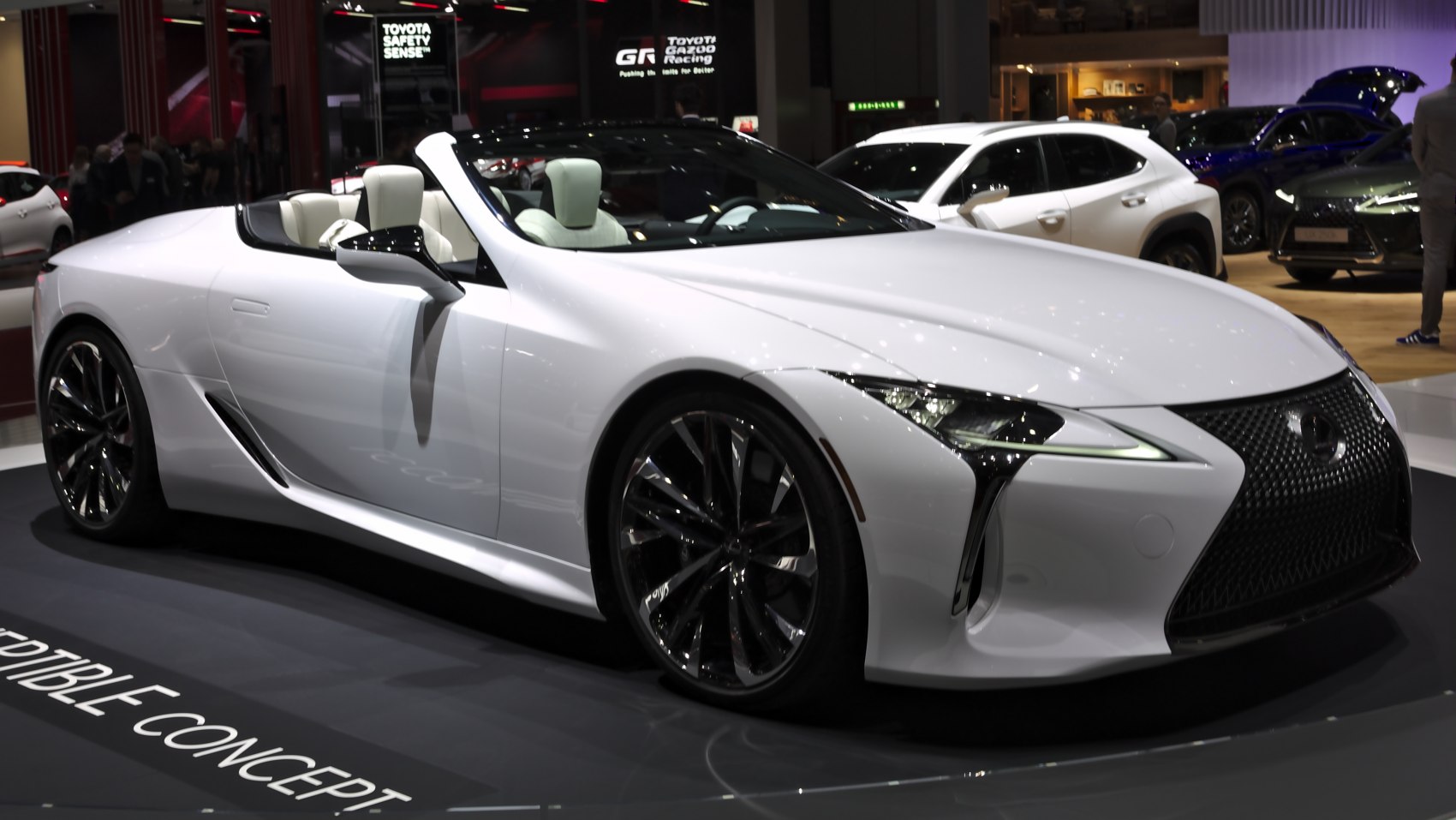 White convertible sports car with aerodynamic body and LED headlights