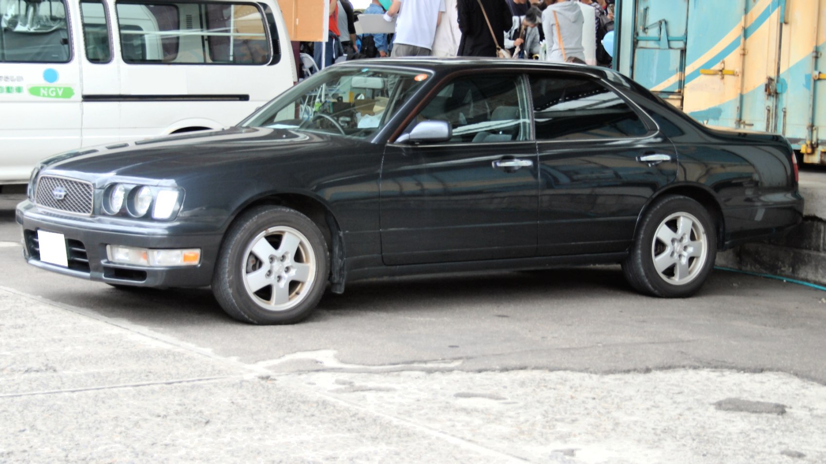 Large sedan side profile with quad front headlights and distinctive grille
