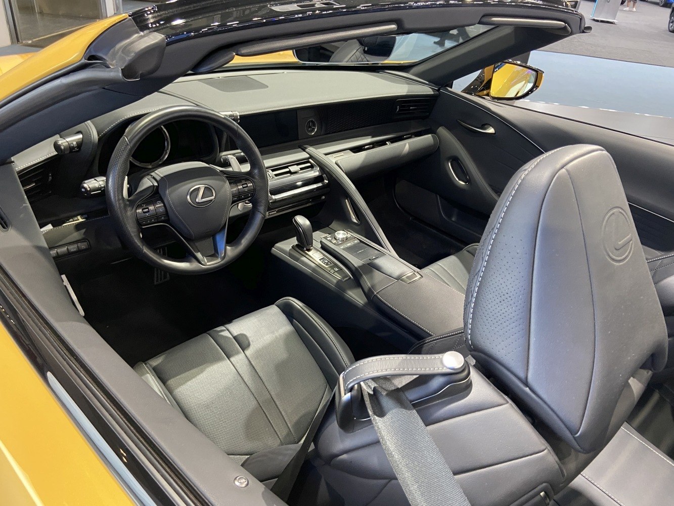 Convertible interior with modern steering wheel and sleek center console.