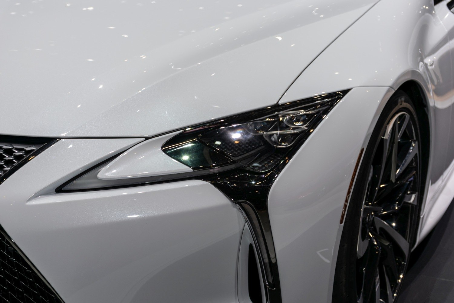 Close-up of front headlight and wheel with sleek design