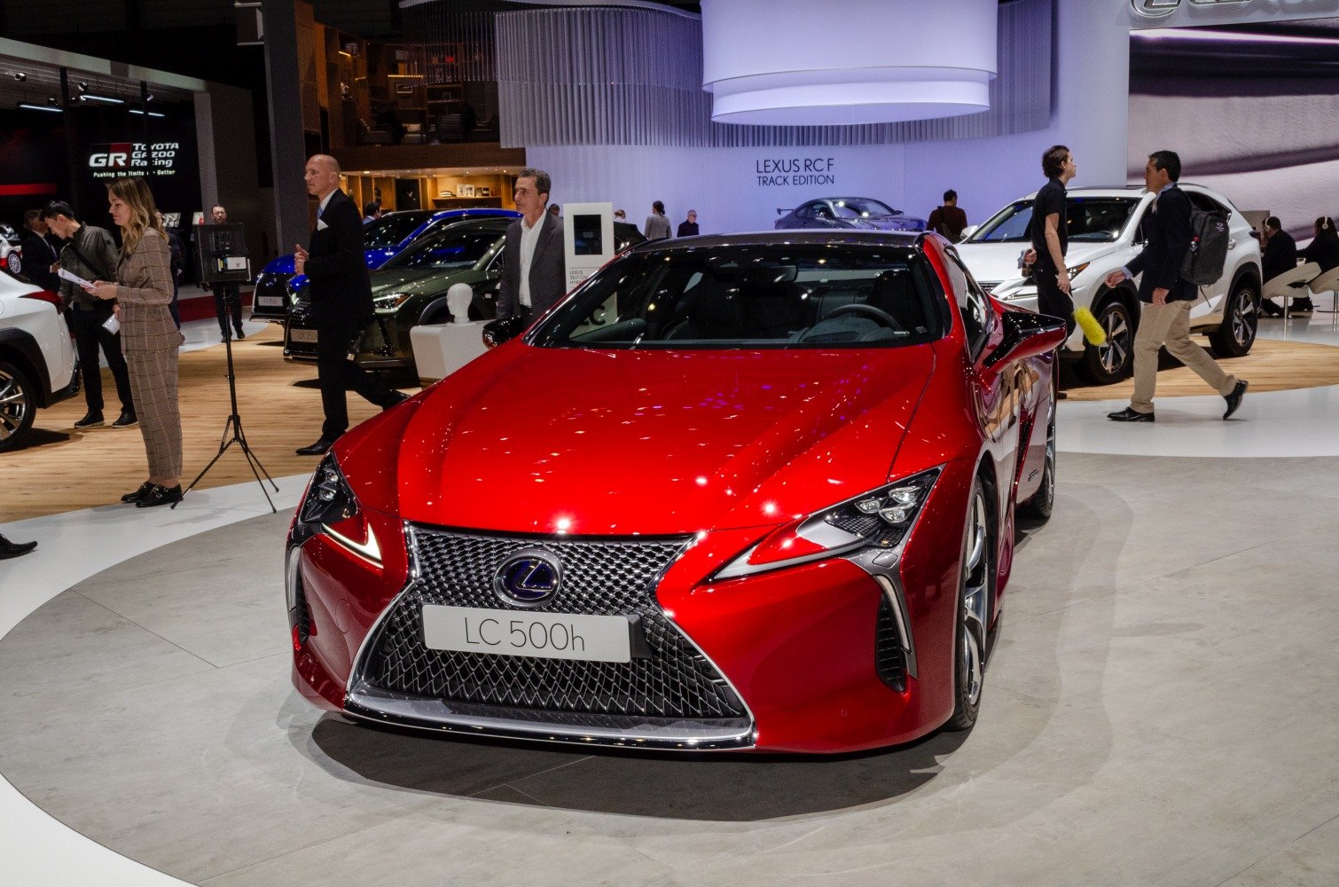 Red hybrid sports coupe front with aggressive grille and LED headlights