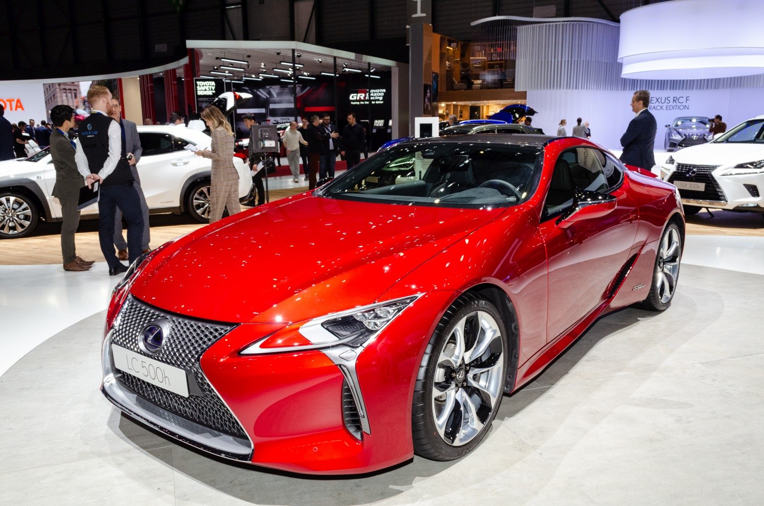 Front view of sleek red hybrid sports coupe with LED headlights and alloy wheels.