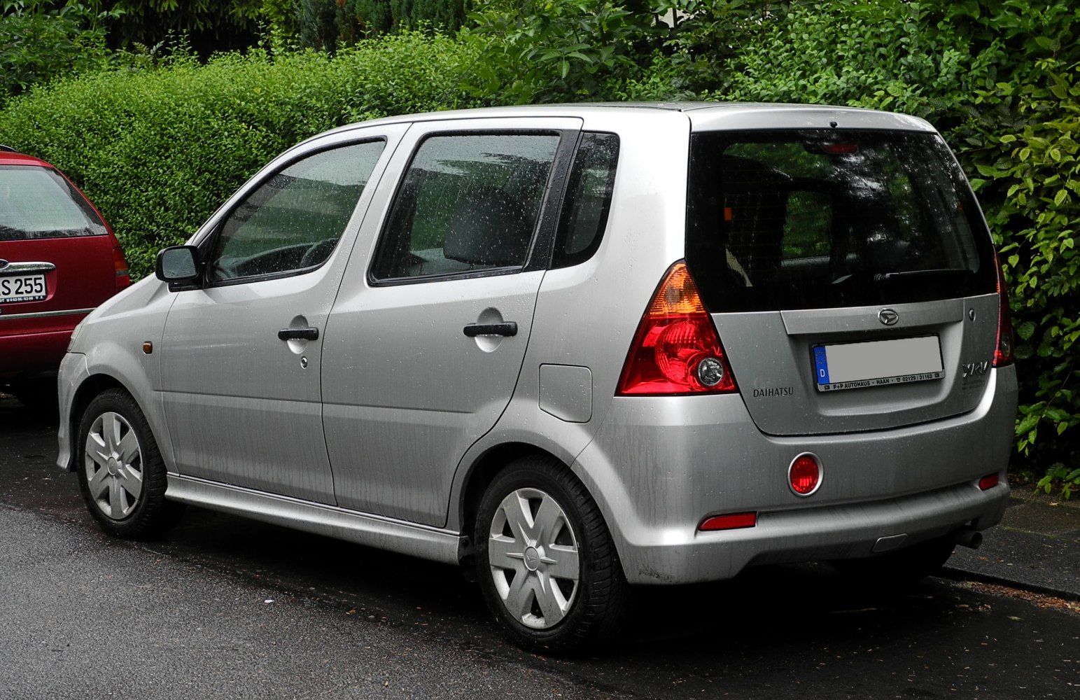 Silver hatchback rear-side with distinct tail lights