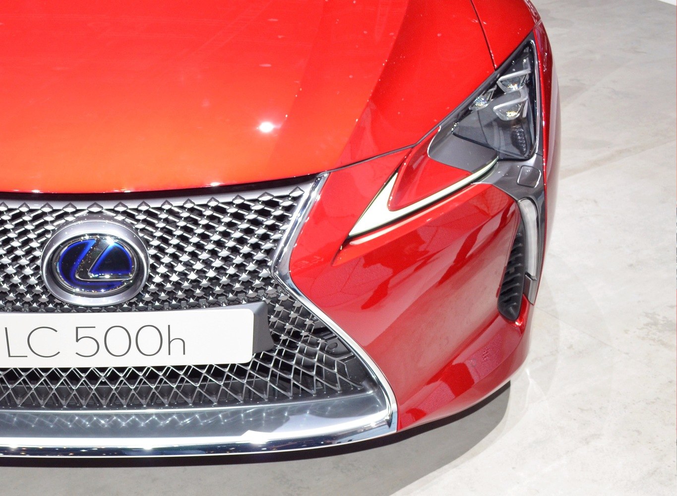 Close-up of car front grille and sharp LED headlight design
