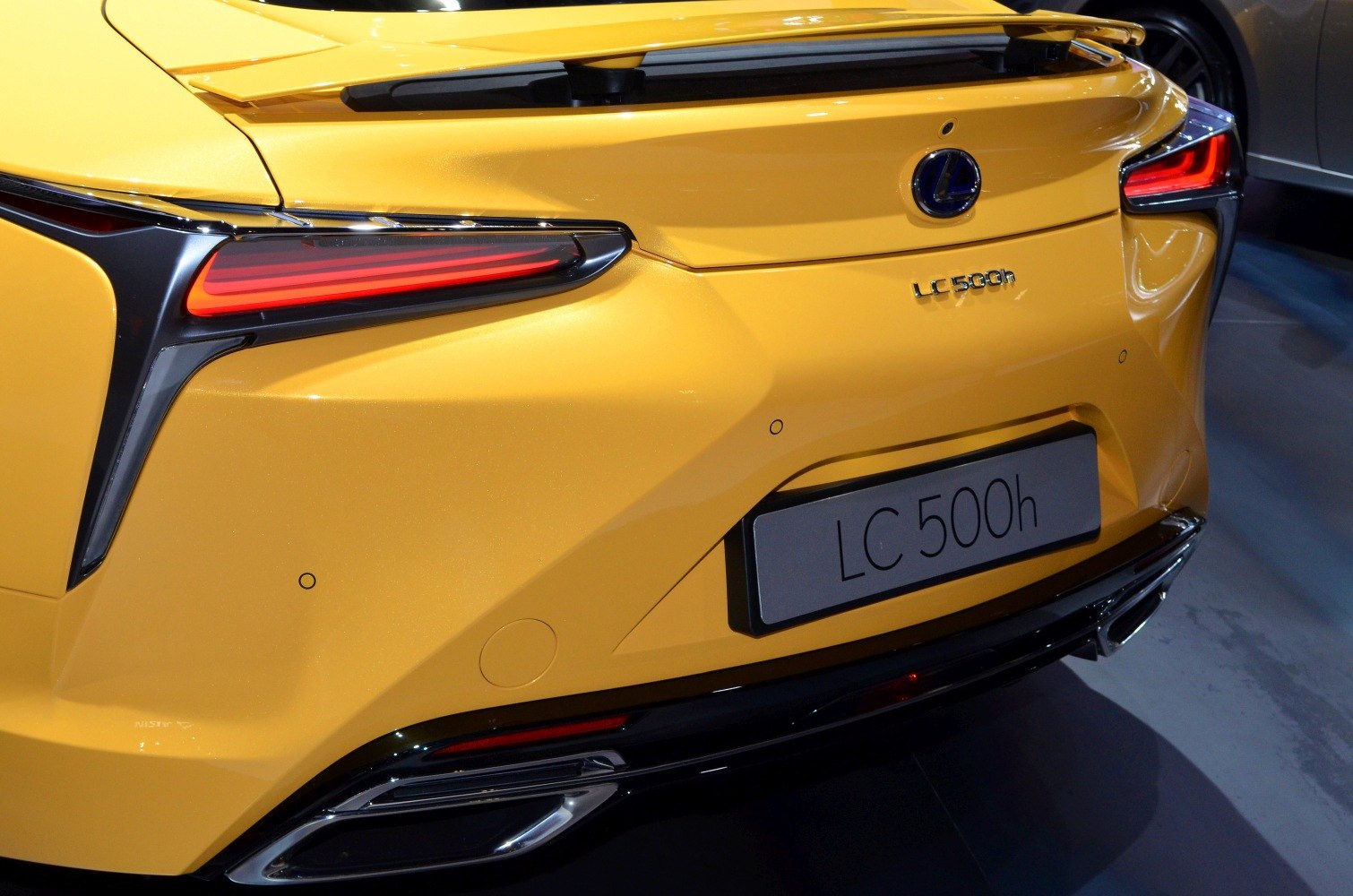 Sharp LED tail lights and aerodynamic rear of a luxury coupe