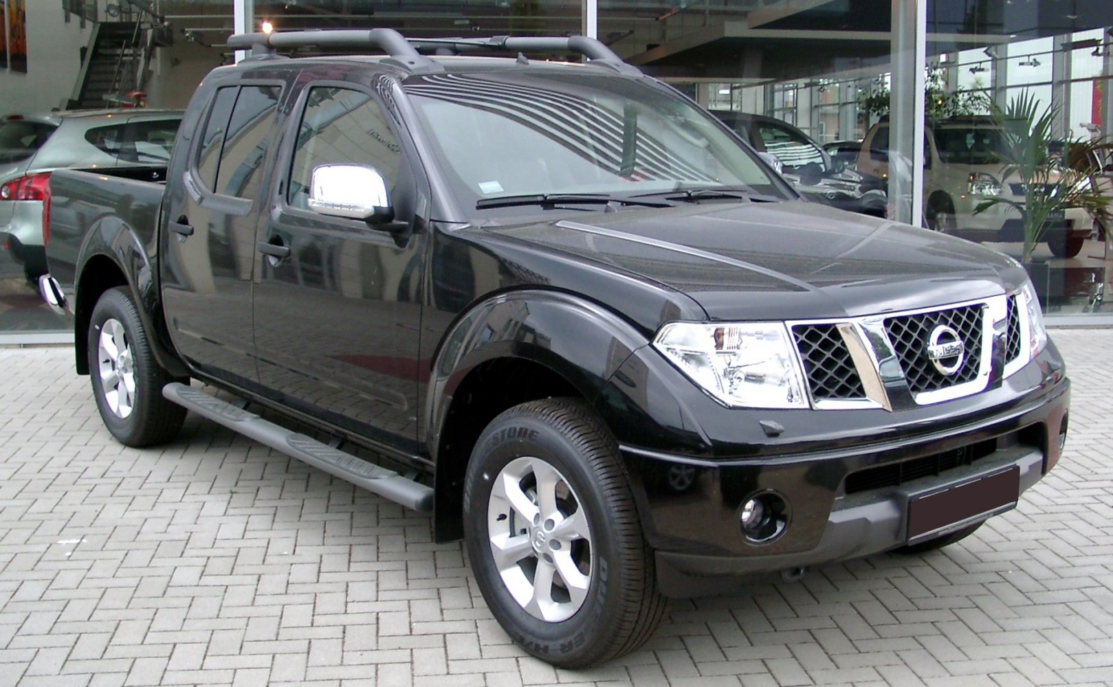 Black double cab pickup with alloy wheels and side steps