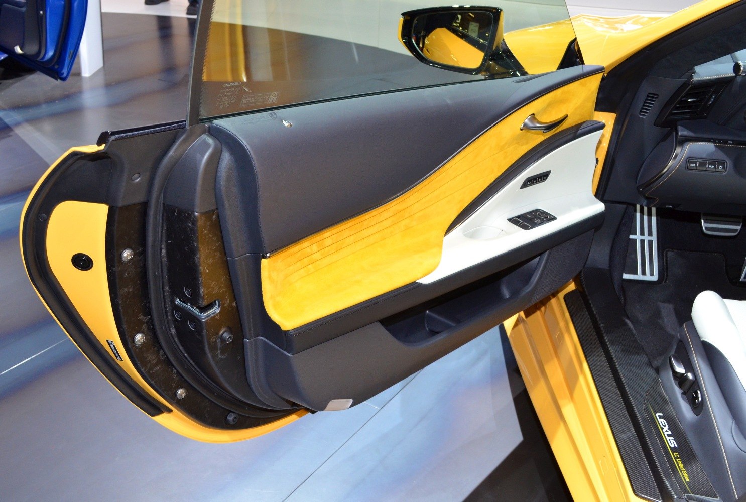 Yellow and black leather interior door panel with control buttons